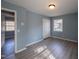 Light-filled bedroom features a closet, wood-look floors, and fresh paint at 817 S Brake St, Nashville, NC 27856