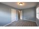 Sunlit bedroom featuring stylish gray walls, durable wood-look flooring, and bright windows at 817 S Brake St, Nashville, NC 27856