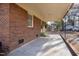 Covered patio showing brick exterior wall and access to the backyard at 817 S Brake St, Nashville, NC 27856