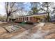 A charming brick home featuring a covered carport and quaint green porch steps at 817 S Brake St, Nashville, NC 27856