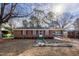 Charming brick home with red shutters, a bright green porch, and a spacious carport at 817 S Brake St, Nashville, NC 27856