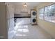 Well-lit kitchen with white appliances, cabinets, and a stacked washer and dryer for convenience at 817 S Brake St, Nashville, NC 27856