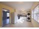 Bright kitchen featuring white cabinets, appliances, and a stacked washer and dryer at 817 S Brake St, Nashville, NC 27856