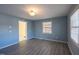 Inviting living room with gray walls and laminate flooring, bathed in natural light from multiple windows at 817 S Brake St, Nashville, NC 27856