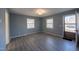 Inviting living room featuring laminate floors, neutral paint and natural light from two windows at 817 S Brake St, Nashville, NC 27856