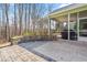 Backyard concrete and paver patio with access to a screened-in porch with wooded views at 86 Pappy Ln, Garner, NC 27529