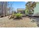 View of the green home, yard, patio and screened-in porch at 86 Pappy Ln, Garner, NC 27529