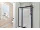 Modern bathroom featuring a glass-enclosed shower and window with natural light at 86 Pappy Ln, Garner, NC 27529