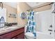 Bathroom featuring granite countertops, decorative nautical elements, and a shower with a colorful curtain at 86 Pappy Ln, Garner, NC 27529