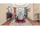 Formal dining room with elegant furnishings, including a chandelier, decorative rug, and sophisticated decor at 86 Pappy Ln, Garner, NC 27529