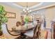 Formal dining room featuring an elegant chandelier, wood table, and bright yellow tulips at 86 Pappy Ln, Garner, NC 27529