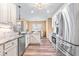 Spacious kitchen with stainless steel appliances, white cabinetry, and wood flooring at 86 Pappy Ln, Garner, NC 27529