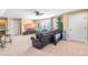 A spacious living room with a comfortable leather sofa, media center, and natural lighting at 86 Pappy Ln, Garner, NC 27529