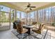 Cozy screened porch with a ceiling fan, fire table, grill, and comfortable seating, perfect for outdoor enjoyment at 86 Pappy Ln, Garner, NC 27529