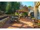 Charming outdoor brick patio with a pergola, seating area and grill, perfect for entertaining and relaxation at 8600 Paddle Wheel Dr, Raleigh, NC 27615