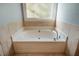 Bright bathroom showcasing a relaxing soaking tub with elegant tile accents at 8600 Paddle Wheel Dr, Raleigh, NC 27615