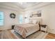 Cozy bedroom with tray ceilings, wood floors, natural light, and stylish decor at 8600 Paddle Wheel Dr, Raleigh, NC 27615