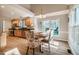 Bright dining area with wood floors, a window view and adjacent kitchen space at 8600 Paddle Wheel Dr, Raleigh, NC 27615