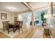 Open-concept dining area with hardwood floors, stylish lighting, and seamless flow to the living room at 8600 Paddle Wheel Dr, Raleigh, NC 27615