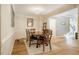 Dining room boasts hardwood flooring, decorative lighting, and elegant wainscoting at 8600 Paddle Wheel Dr, Raleigh, NC 27615