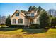 Charming two-story home with a well-manicured lawn and mature trees at 8600 Paddle Wheel Dr, Raleigh, NC 27615