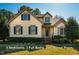 Charming two-story home with blue shutters and a well-manicured front lawn at 8600 Paddle Wheel Dr, Raleigh, NC 27615