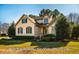 Beautiful two-story home featuring mature trees, a manicured lawn, and classic architecture at 8600 Paddle Wheel Dr, Raleigh, NC 27615