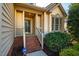 Welcoming front porch with brick steps, white railings, and tasteful exterior lighting at 8600 Paddle Wheel Dr, Raleigh, NC 27615