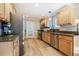 Spacious kitchen featuring stainless steel appliances, granite countertops, and wood cabinets at 8600 Paddle Wheel Dr, Raleigh, NC 27615
