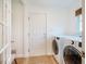 Bright laundry room featuring modern washer and dryer units, as well as tile flooring at 8600 Paddle Wheel Dr, Raleigh, NC 27615
