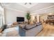 Open-concept living room with hardwood floors, recessed lighting, and a seamless transition to the dining area at 8600 Paddle Wheel Dr, Raleigh, NC 27615
