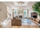 Cozy living room featuring a fireplace, tray ceiling, hardwood floors, and ample natural light at 8600 Paddle Wheel Dr, Raleigh, NC 27615
