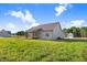 Expansive backyard view of the home with a screened-in porch, patio, and lush green grass at 9315 Turkey Way, Middlesex, NC 27557