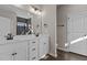 Bathroom featuring double sinks with modern fixtures, sleek black brick style tile, and white cabinets at 9315 Turkey Way, Middlesex, NC 27557