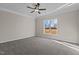 Neutral bedroom with a ceiling fan, carpet, and a window with a view of the outdoors at 9315 Turkey Way, Middlesex, NC 27557