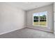 Neutral bedroom features plush carpet, white trim, and a large window at 9315 Turkey Way, Middlesex, NC 27557