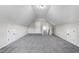 Spacious bonus room with neutral carpet, bright white walls, and access to the stairway at 9315 Turkey Way, Middlesex, NC 27557