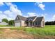New construction home featuring a two-car garage, charming front porch and lush green lawn at 9315 Turkey Way, Middlesex, NC 27557