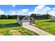 An elevated view showing a two story home on a large lot with an attached garage and concrete driveway at 9315 Turkey Way, Middlesex, NC 27557