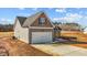 Exterior of a two-story home with a garage and a concrete driveway on a sunny day at 9315 Turkey Way, Middlesex, NC 27557