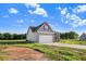 New construction home featuring a two-car garage, charming front porch and lush green lawn at 9315 Turkey Way, Middlesex, NC 27557