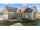 Charming single-story home with a gray exterior, covered porch and an attached garage at 9315 Turkey Way, Middlesex, NC 27557