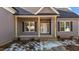 Inviting covered front porch with brick steps and wood columns at 9315 Turkey Way, Middlesex, NC 27557