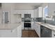 Well-lit kitchen featuring modern appliances, white cabinets, and tiled backsplash at 9315 Turkey Way, Middlesex, NC 27557