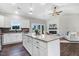 Open kitchen and living room area with island, white cabinets, fireplace, and stainless steel appliances at 9315 Turkey Way, Middlesex, NC 27557