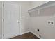 Functional laundry room with a white door, shelf, and utility connections at 9315 Turkey Way, Middlesex, NC 27557