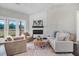 Bright and cozy living room with a fireplace, shiplap accent wall, comfortable seating, and a neutral color palette at 9315 Turkey Way, Middlesex, NC 27557
