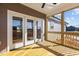 Covered patio with wood flooring, ceiling fan, and a view of the expansive, unfinished yard at 9315 Turkey Way, Middlesex, NC 27557