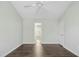 Empty bedroom with ceiling fan, neutral paint, wood flooring, and door to another room at 938 Widewaters Pkwy, Knightdale, NC 27545