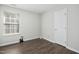 Neutral bedroom with natural light, hard surface floors, and white door at 938 Widewaters Pkwy, Knightdale, NC 27545